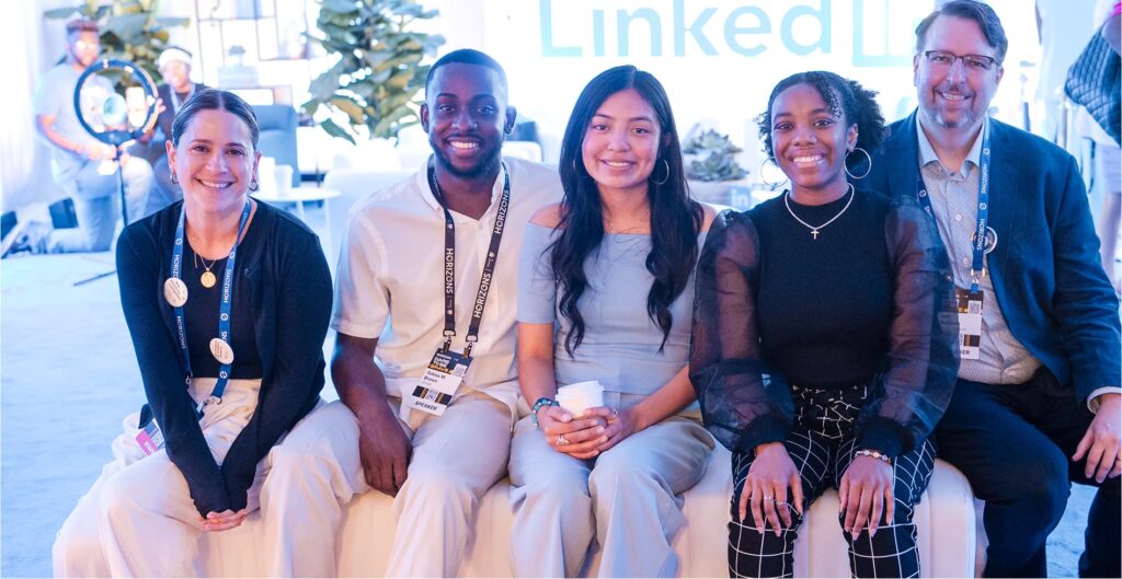 A group of five people smiling while sitting together at a LinkedIn event