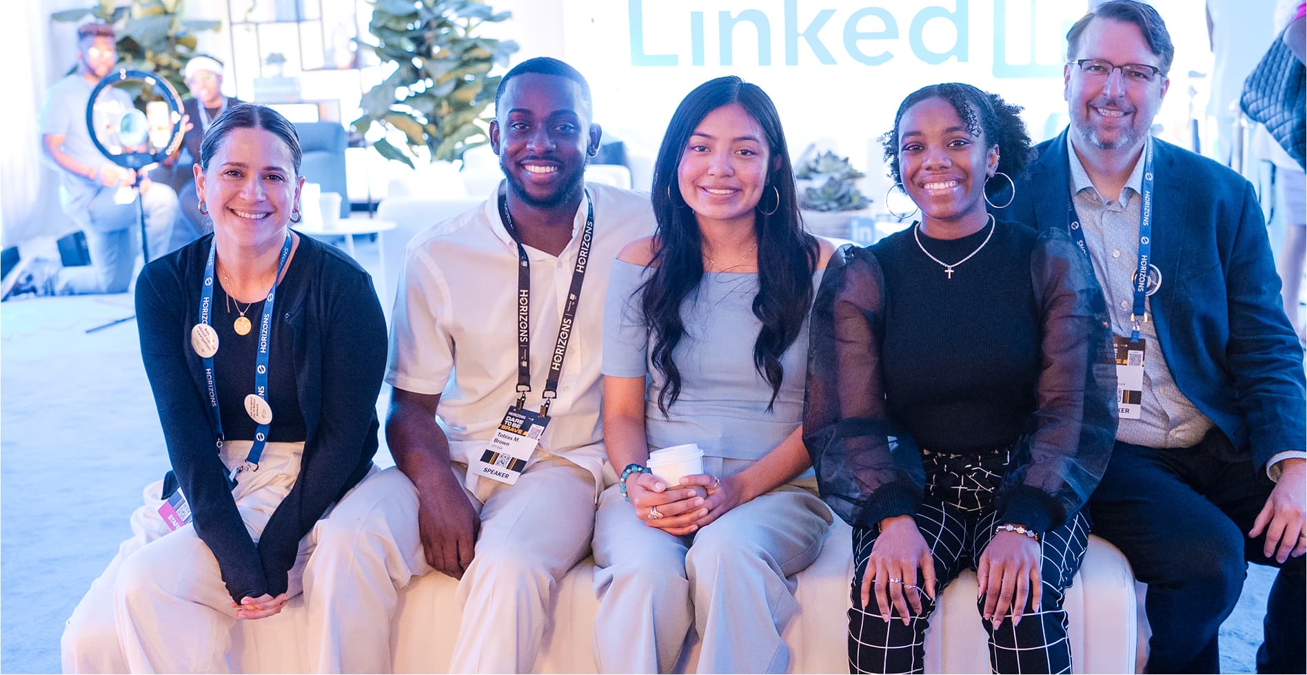 A group of five people smiling while sitting together at a LinkedIn event